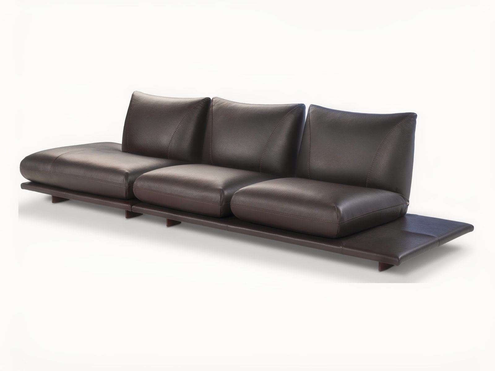 PRALIN Modular 'Pralin' sofa with removable elements, wooden feet, and versatile configurations, including a day bed and integrated table, ensures customizable comfort and relaxation.