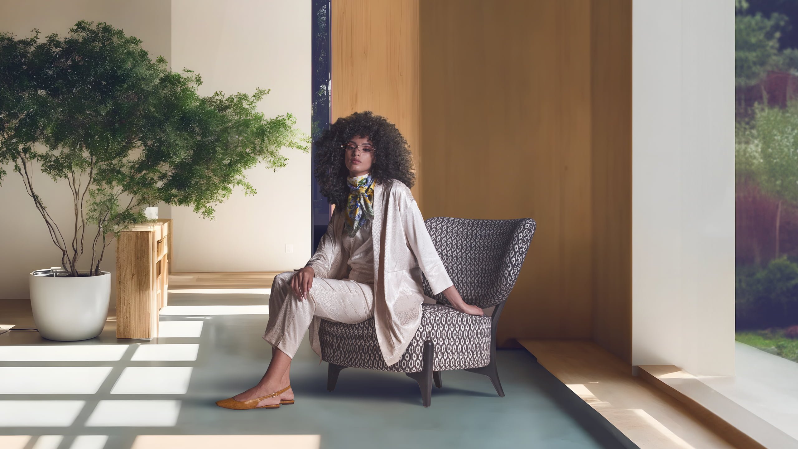 SILLA The 'Silla' armchair features a distinctive embracing backrest and sturdy external legs, offering both comfort and a stylized, Scandinavian-inspired design.