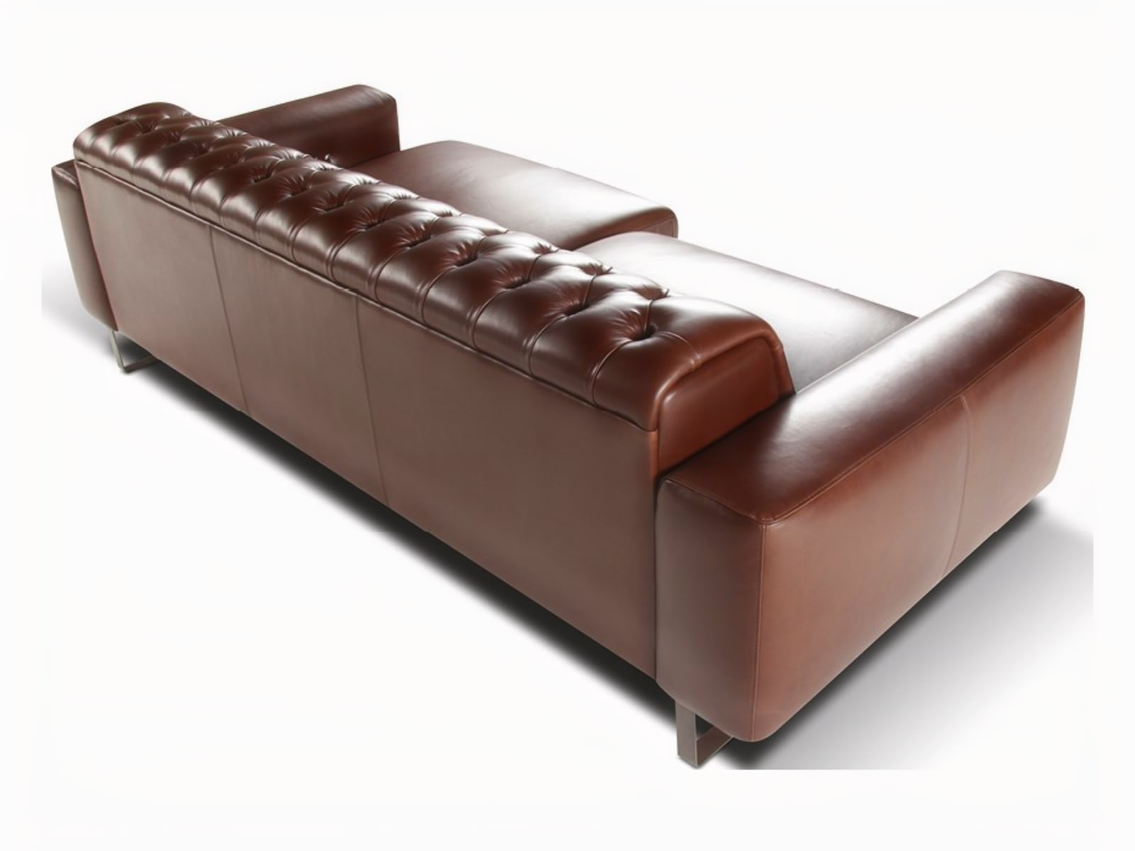 NIOBE Elegant Niobe sofa with classic tufted headboard blends craftsmanship and comfort, featuring optional motion seats, and a choice of leather, fabric, or microfiber coverings.
