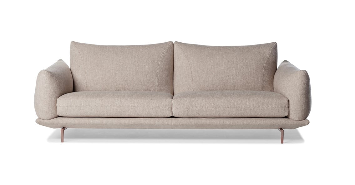 DRAGÉES Elegant sectional with heightened backrests for superior comfort, minimal base, and decorative stitching, combining sophistication with supported relaxation.