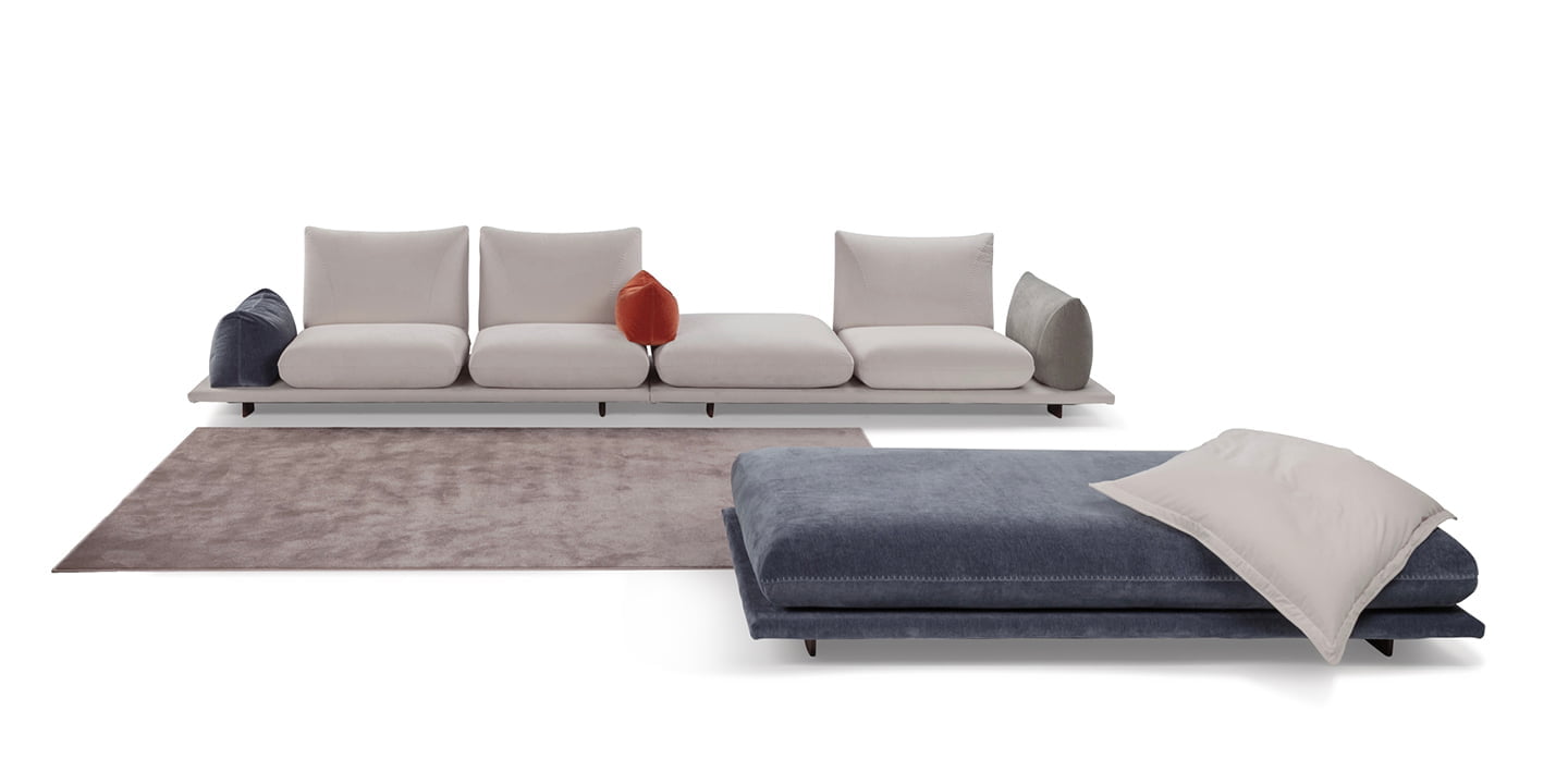 PRALIN Modular 'Pralin' sofa with removable elements, wooden feet, and versatile configurations, including a day bed and integrated table, ensures customizable comfort and relaxation. PRALIN Modular 'Pralin' sofa with removable elements, wooden feet, and versatile configurations, including a day bed and integrated table, ensures customizable comfort and relaxation.