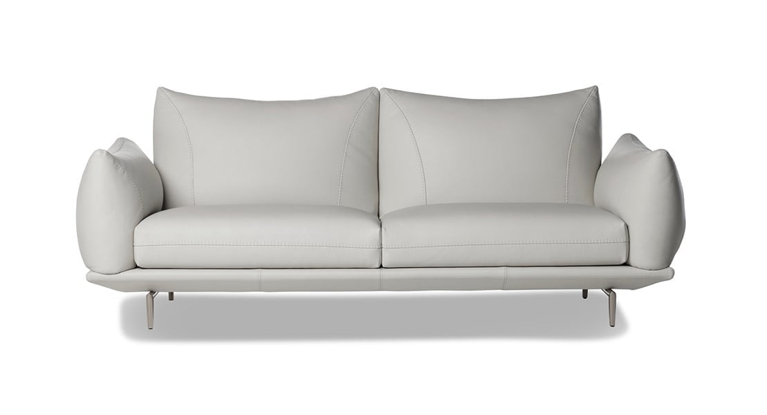 DRAGÉES Elegant sectional with heightened backrests for superior comfort, minimal base, and decorative stitching, combining sophistication with supported relaxation.