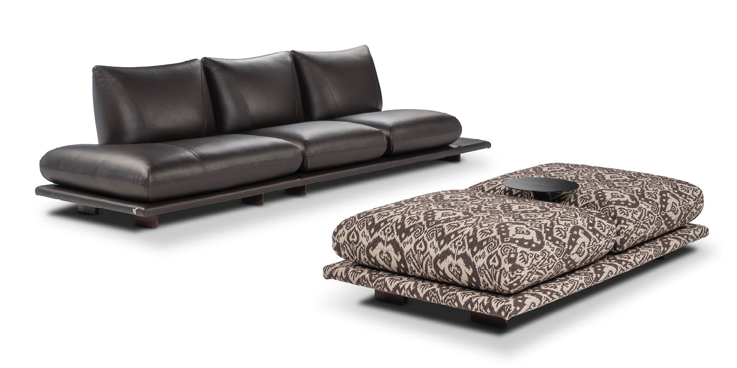 PRALIN Modular 'Pralin' sofa with removable elements, wooden feet, and versatile configurations, including a day bed and integrated table, ensures customizable comfort and relaxation.