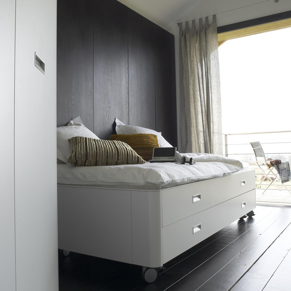 TRAVEL STUDIO Wooden storage bed on castors