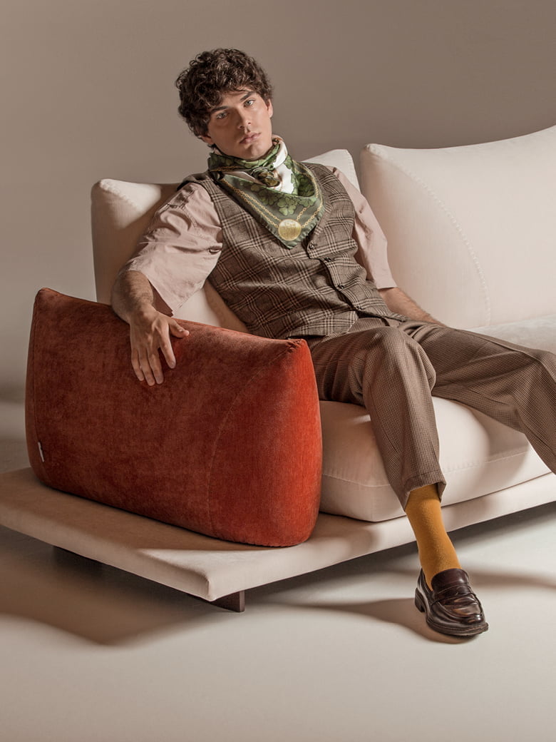 PRALIN Modular 'Pralin' sofa with removable elements, wooden feet, and versatile configurations, including a day bed and integrated table, ensures customizable comfort and relaxation.