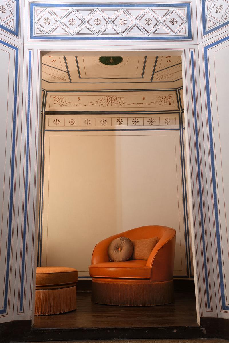 DIONE Upholstered leather armchair with armrests