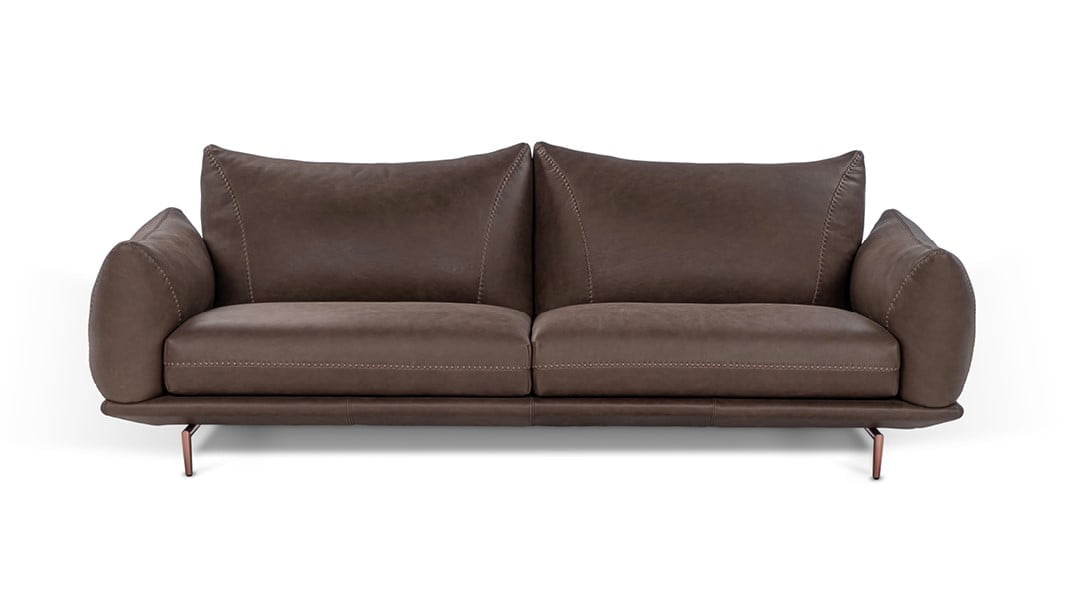 DRAGÉES Elegant sectional with heightened backrests for superior comfort, minimal base, and decorative stitching, combining sophistication with supported relaxation.